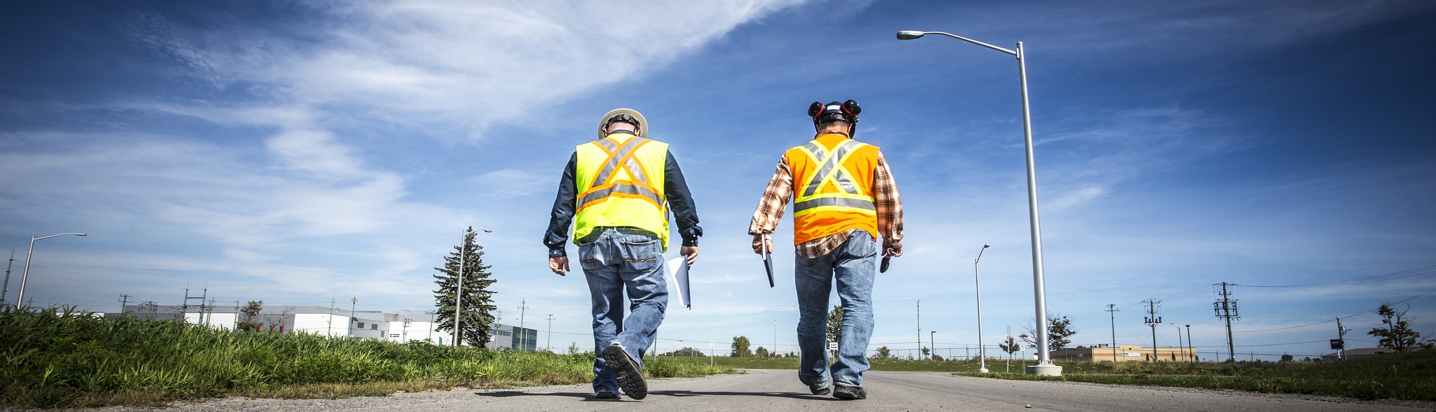 Consultants walking on the property of the Durham York Energy Centre